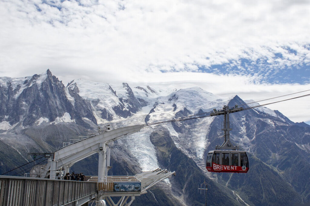 Cable car going up with the snow-covered Chamonix Mont Blanc in the background