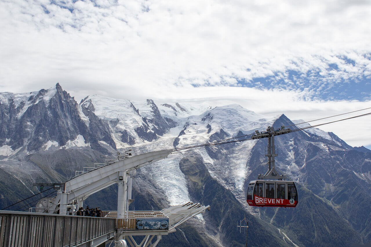 Cable car going up with the snow-covered Chamonix Mont Blanc in the background