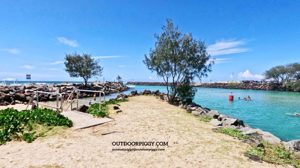 People swimming where the sea and river meet at Kingscliff