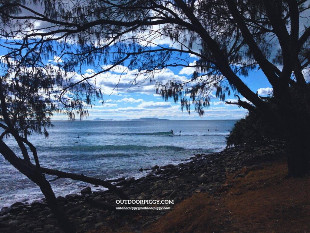 Crescent Head Beach in Australia with surfers riding the waves.